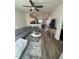 Open concept living room with kitchen in background showcases modern living and dining spaces at 829 S Franklin St, Wake Forest, NC 27587