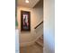 Carpeted staircase featuring decorative wall art and a wooden handrail at 829 S Franklin St, Wake Forest, NC 27587