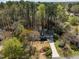Aerial view of the home shows its established neighborhood, attached garage, mature landscaping, and long driveway at 8429 Bells Lake Rd, Apex, NC 27539