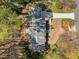 Aerial view shows a well-maintained roof, long driveway, mature trees, and thoughtful landscaping at 8429 Bells Lake Rd, Apex, NC 27539
