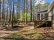 View of the backyard deck and screened porch with view to the wooded, sunny backyard at 8429 Bells Lake Rd, Apex, NC 27539