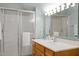 Bright bathroom features a vanity with a sink and faucet, a large mirror, and a stand-up shower at 8429 Bells Lake Rd, Apex, NC 27539