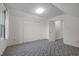Well-lit bedroom with plush carpet, double door closet, and ample natural light at 8429 Bells Lake Rd, Apex, NC 27539