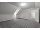 Upstairs bonus room features neutral walls, plush carpeting, and easy access to a hallway bathroom at 8429 Bells Lake Rd, Apex, NC 27539