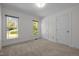 Carpeted bedroom with natural light from two windows at 8429 Bells Lake Rd, Apex, NC 27539