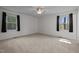 Bright bedroom with two windows, neutral walls, and ceiling fan at 8429 Bells Lake Rd, Apex, NC 27539