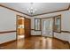 Formal dining room features hardwood floors, chandelier, and access to the kitchen at 8429 Bells Lake Rd, Apex, NC 27539