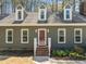 Inviting home showcasing a decorative front door, dormer windows, and manicured landscaping at 8429 Bells Lake Rd, Apex, NC 27539