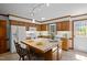 Well-lit kitchen features wood cabinets, white appliances, and a functional island at 8429 Bells Lake Rd, Apex, NC 27539