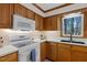 Bright kitchen showcasing wood cabinets, a white countertop, and a view of the outdoors at 8429 Bells Lake Rd, Apex, NC 27539