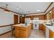 Cozy kitchen offering wood cabinetry, a center island, and essential appliances at 8429 Bells Lake Rd, Apex, NC 27539
