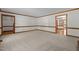 Expansive living room with neutral carpet, classic trim, and open doorway at 8429 Bells Lake Rd, Apex, NC 27539