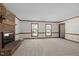 Spacious living room features carpet, a fireplace, and natural light from large windows at 8429 Bells Lake Rd, Apex, NC 27539