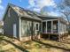 Home's rear exterior shows a screened porch, sturdy siding, and a brick foundation in a well-maintained yard at 8429 Bells Lake Rd, Apex, NC 27539