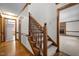 Staircase features wood trim, carpeted steps, and leads to an additional room with a brick fireplace at 8429 Bells Lake Rd, Apex, NC 27539