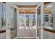 Inviting sunroom filled with natural light, a wooden ceiling, and views of the outdoors at 8429 Bells Lake Rd, Apex, NC 27539