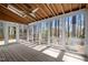 Bright sunroom with a wood deck, screened windows, and an airy atmosphere at 8429 Bells Lake Rd, Apex, NC 27539