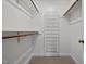 Well-organized walk-in closet with shelves and rod for storage at 8429 Bells Lake Rd, Apex, NC 27539