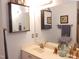 Neutral colored bathroom with vanity and decorative bird sculptures at 903 Teague Pl, Durham, NC 27707