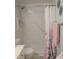 Clean, white tiled shower and grab bar for accessibility at 903 Teague Pl, Durham, NC 27707