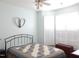 Bright bedroom with a decorative quilt, ceiling fan and plantation shutters at 903 Teague Pl, Durham, NC 27707