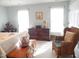Large bedroom with wicker chair and sunny windows at 903 Teague Pl, Durham, NC 27707
