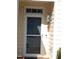 Inviting front door with glass accents, classic lantern, and neutral-toned siding at 903 Teague Pl, Durham, NC 27707