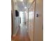 Well-lit hallway featuring laminate wood flooring and closet space at 903 Teague Pl, Durham, NC 27707