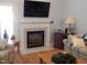 Cozy living room with fireplace, hardwood floors, and comfortable seating at 903 Teague Pl, Durham, NC 27707