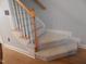 Carpeted staircase with wood trim and white railings at 903 Teague Pl, Durham, NC 27707