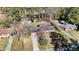 An aerial view showcasing the home's roof, driveway, and the surrounding mature trees in the neighborhood at 914 S Crescent Dr, Smithfield, NC 27577
