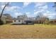 Wide view of the private backyard, screened-in porch, and swing set at 914 S Crescent Dr, Smithfield, NC 27577