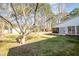 A charming backyard scene with mature trees, a bird bath, and hints of a screened-in porch for relaxation at 914 S Crescent Dr, Smithfield, NC 27577