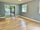 Spacious bedroom with hardwood floors, a sliding glass door leading to a screened porch, and ample natural light at 914 S Crescent Dr, Smithfield, NC 27577
