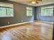 Serene bedroom with hardwood floors, three large windows, and neutral gray walls at 914 S Crescent Dr, Smithfield, NC 27577