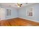 Comfortable bedroom with hardwood floors, blue walls, ceiling fan, and two large windows at 914 S Crescent Dr, Smithfield, NC 27577