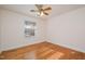 Cozy bedroom with hardwood floors, ceiling fan, and a window providing natural light at 914 S Crescent Dr, Smithfield, NC 27577