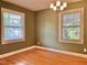 View of an empty dining room showcasing hardwood floors and natural light from large windows at 914 S Crescent Dr, Smithfield, NC 27577