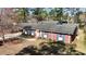 Charming brick home with blue shutters and a wooden door is complemented by mature landscaping at 914 S Crescent Dr, Smithfield, NC 27577