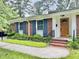 Charming brick home featuring blue shutters, complemented by lush landscaping and a welcoming front porch at 914 S Crescent Dr, Smithfield, NC 27577