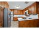 Well-maintained kitchen with wood cabinetry, stone floors, and stainless steel appliances at 914 S Crescent Dr, Smithfield, NC 27577