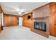 Spacious Gathering room with a brick fireplace, built-in storage, and plush carpeting at 914 S Crescent Dr, Smithfield, NC 27577