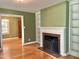 Living room with hardwood floors, a fireplace, and built-in bookshelves at 914 S Crescent Dr, Smithfield, NC 27577