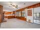 Open-concept space connecting the living room and kitchen featuring a fireplace and wood paneling at 914 S Crescent Dr, Smithfield, NC 27577