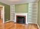 Cozy living room featuring a fireplace with built-in bookshelves and hardwood floors at 914 S Crescent Dr, Smithfield, NC 27577