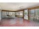 Large screened-in porch with rustic wood floors and a ceiling fan at 914 S Crescent Dr, Smithfield, NC 27577