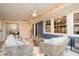 Bright sunroom with neutral furnishings, blue accent wall, ceiling fan, and large windows at 914 S Crescent Dr, Smithfield, NC 27577