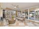 Inviting sunroom with tile floors, neutral furnishings, ceiling fan, and sliding glass doors to a deck at 914 S Crescent Dr, Smithfield, NC 27577