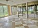 Sunroom with a tiled floor and multiple sliding doors leading to an outdoor space at 914 S Crescent Dr, Smithfield, NC 27577