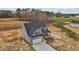Aerial view of gray home with an attached two car garage and a spacious front yard at 9353 Turkey Way, Middlesex, NC 27557